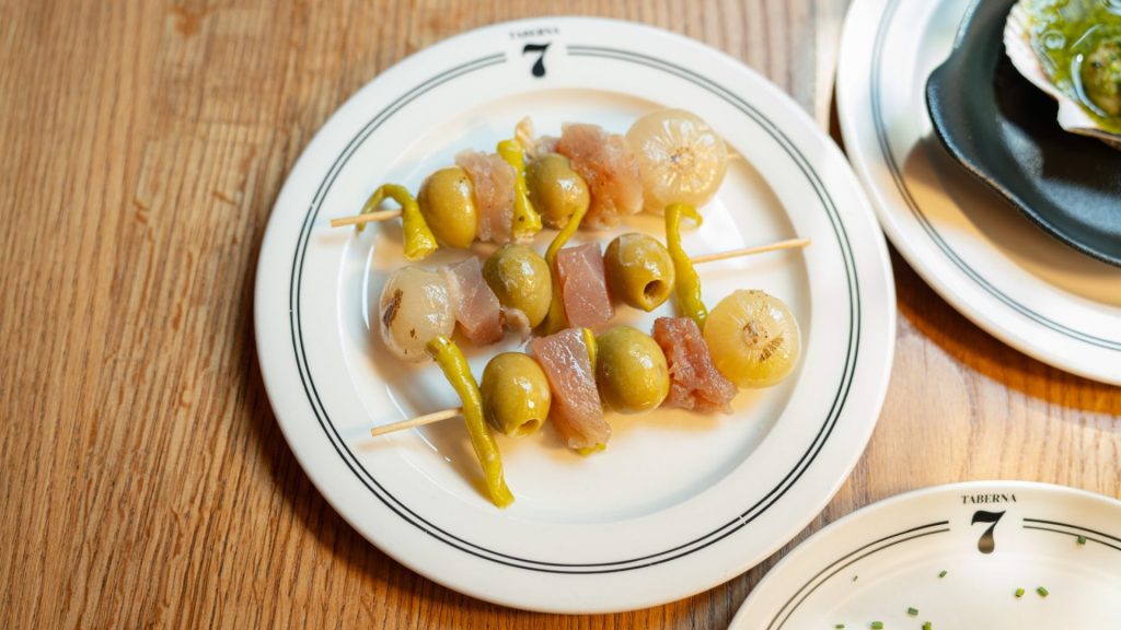 Gildas XL de Taberna 7 con aceitunas, anchoas y piparras en un plato de la casa